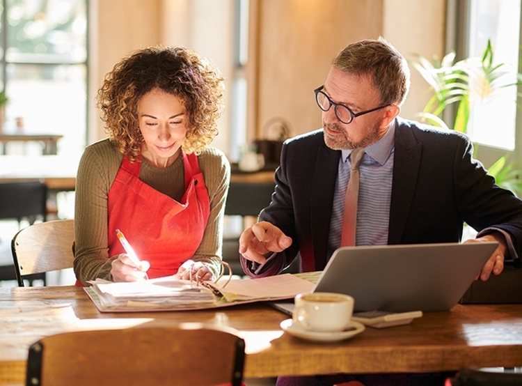 Man and woman looking over papers